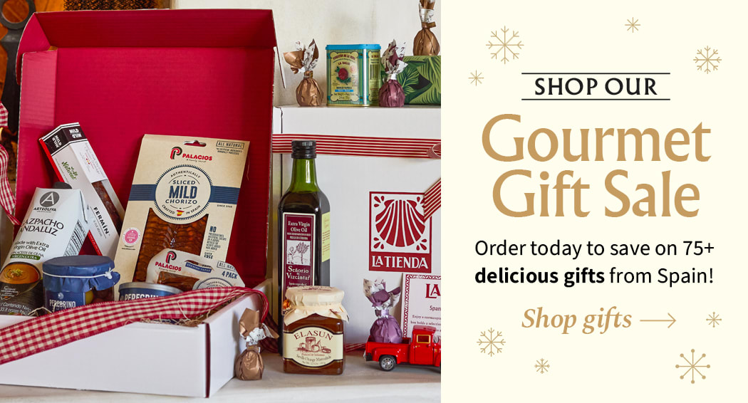 Sliced Jamon in a plate with some olives and a knife out of focus