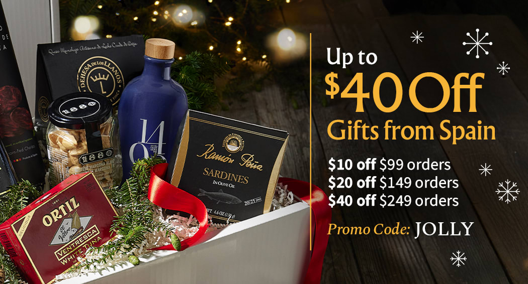 Sliced Jamon in a plate with some olives and a knife out of focus