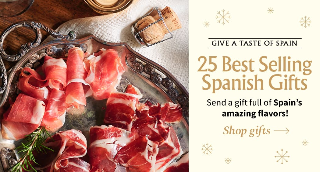 Sliced Jamon in a plate with some olives and a knife out of focus