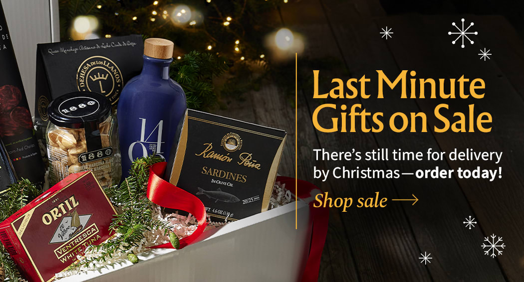 Sliced Jamon in a plate with some olives and a knife out of focus