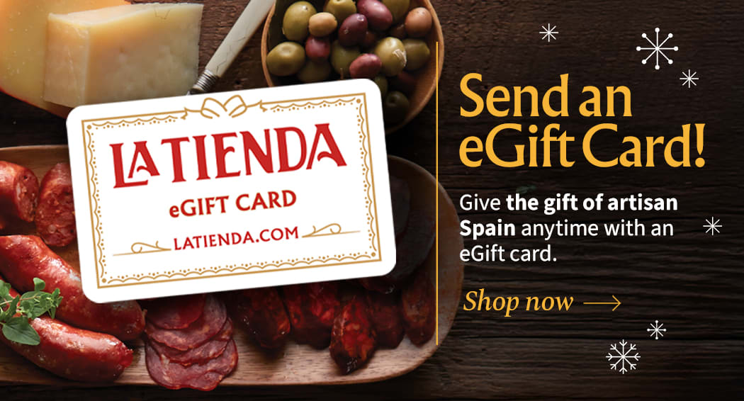 Sliced Jamon in a plate with some olives and a knife out of focus