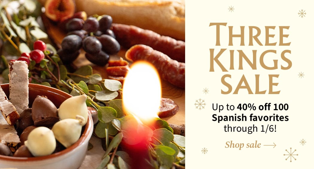 Sliced Jamon in a plate with some olives and a knife out of focus