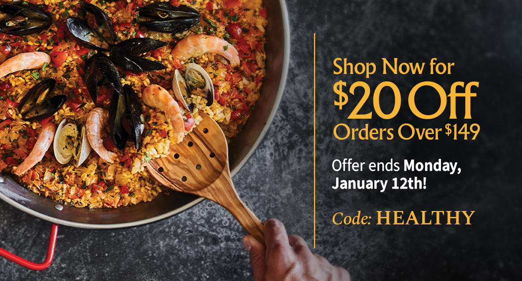 Sliced Jamon in a plate with some olives and a knife out of focus