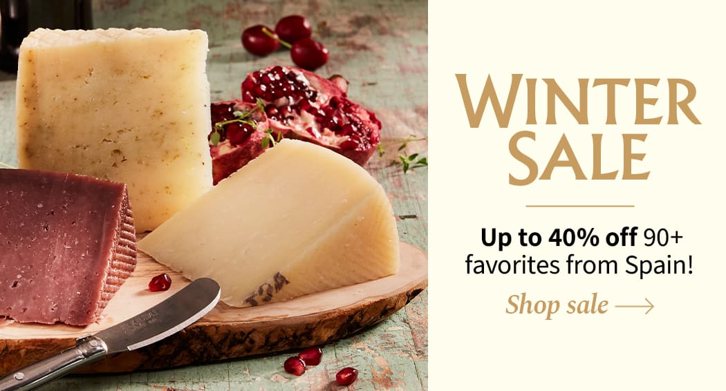 Sliced Jamon in a plate with some olives and a knife out of focus