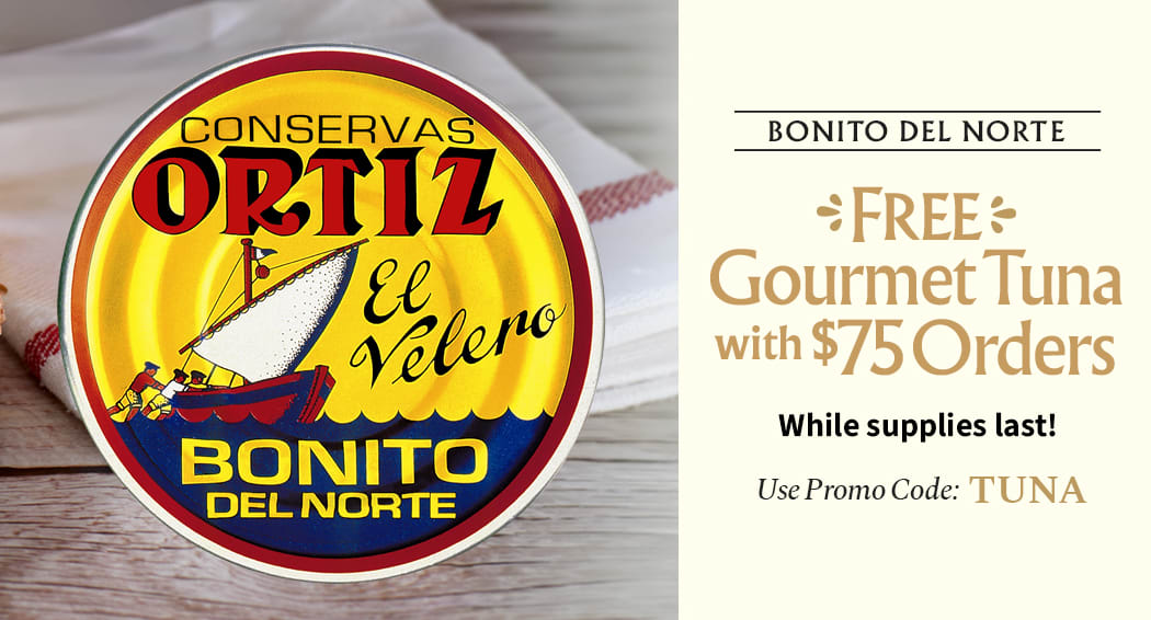 Sliced Jamon in a plate with some olives and a knife out of focus