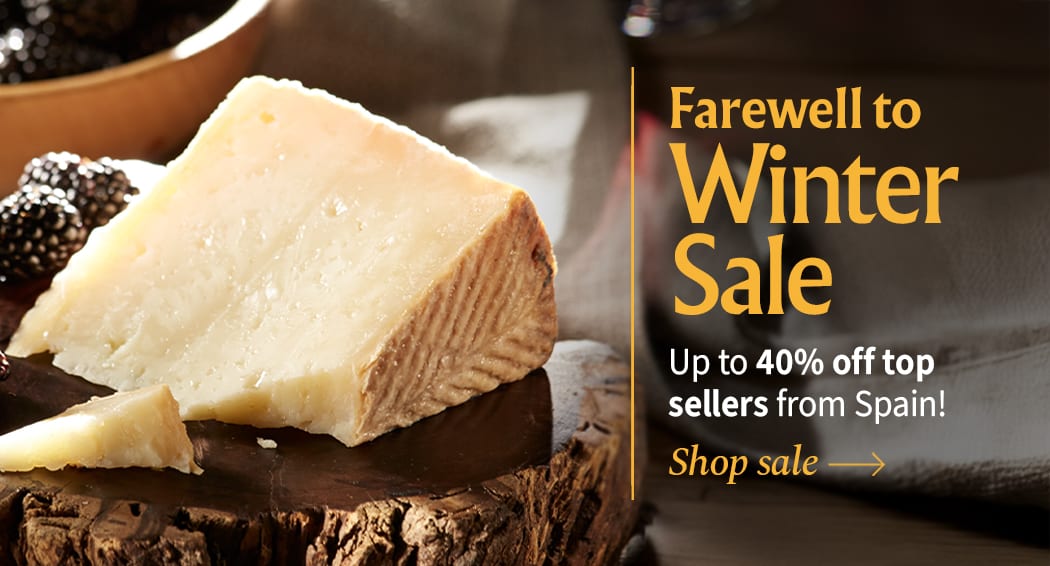 Sliced Jamon in a plate with some olives and a knife out of focus