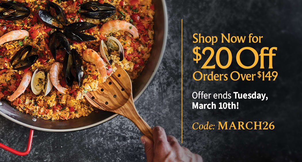 Sliced Jamon in a plate with some olives and a knife out of focus