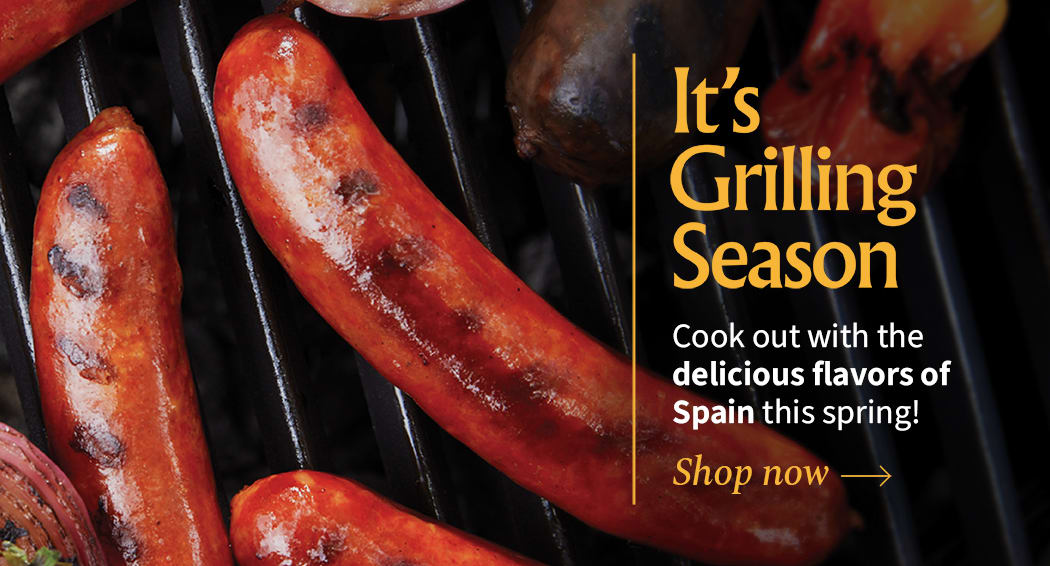 Sliced Jamon in a plate with some olives and a knife out of focus