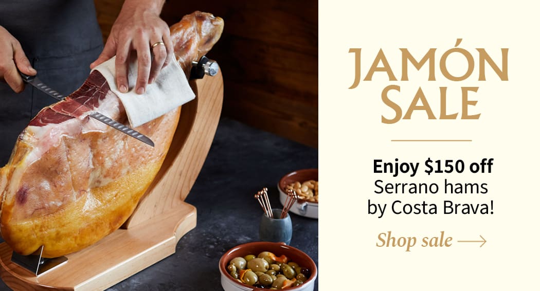 Sliced Jamon in a plate with some olives and a knife out of focus