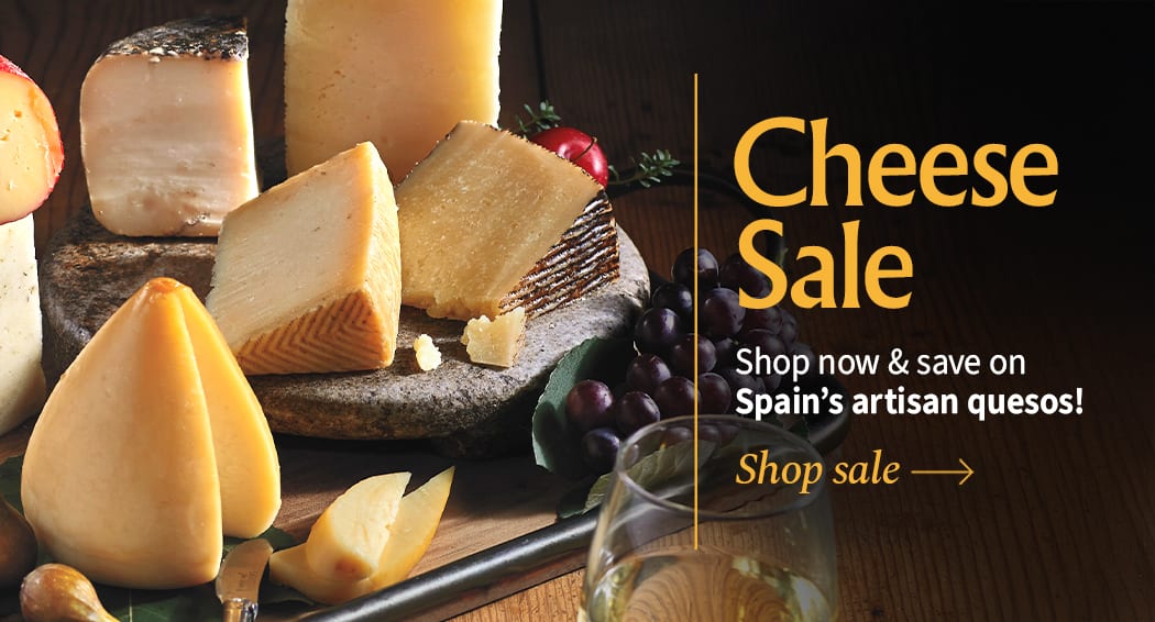 Sliced Jamon in a plate with some olives and a knife out of focus