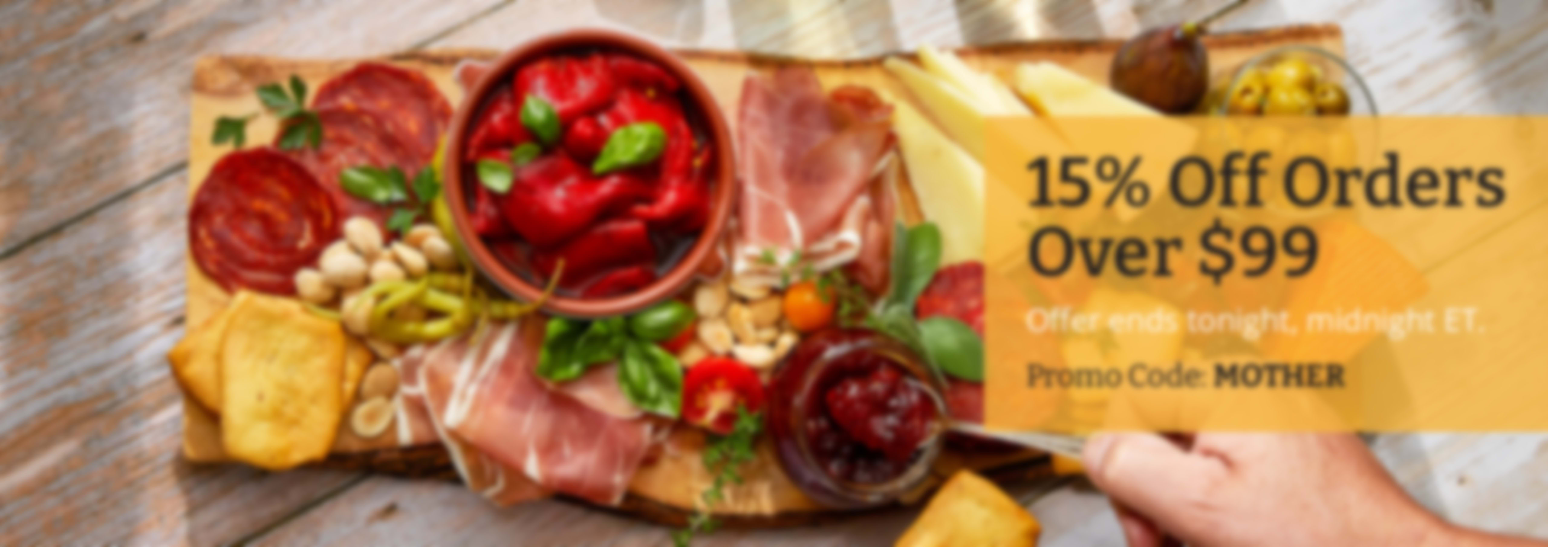 Sliced Jamon in a plate with some olives and a knife out of focus