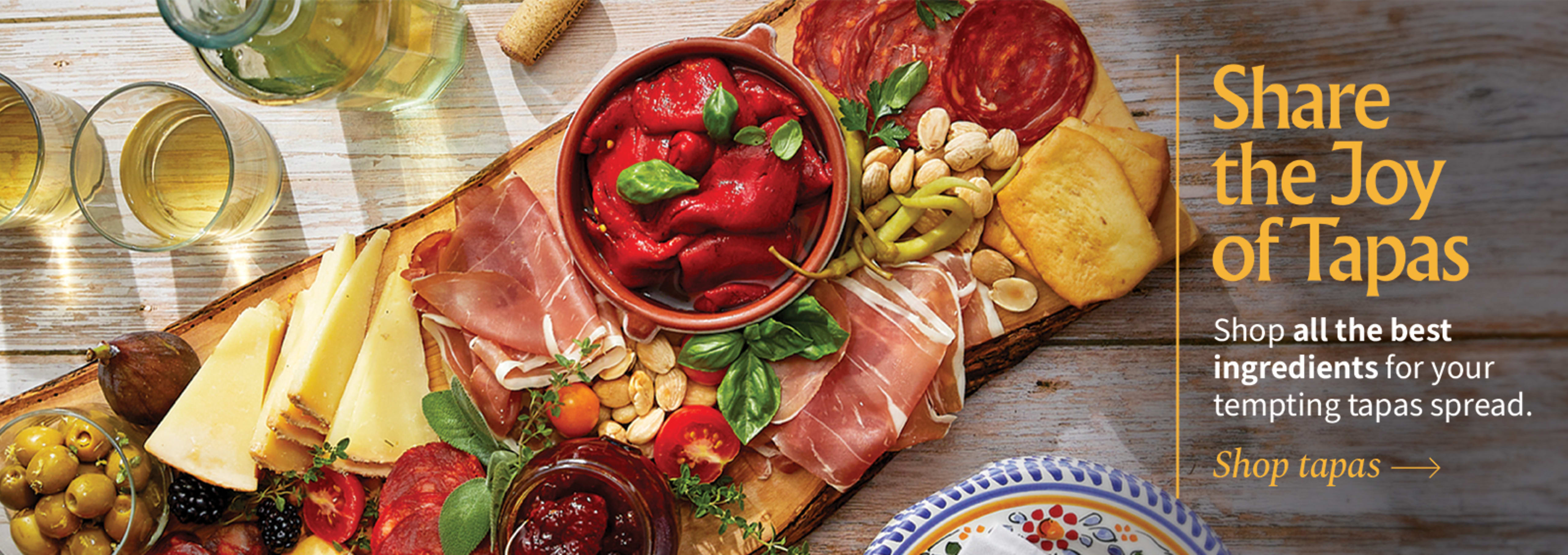 Sliced Jamon in a plate with some olives and a knife out of focus