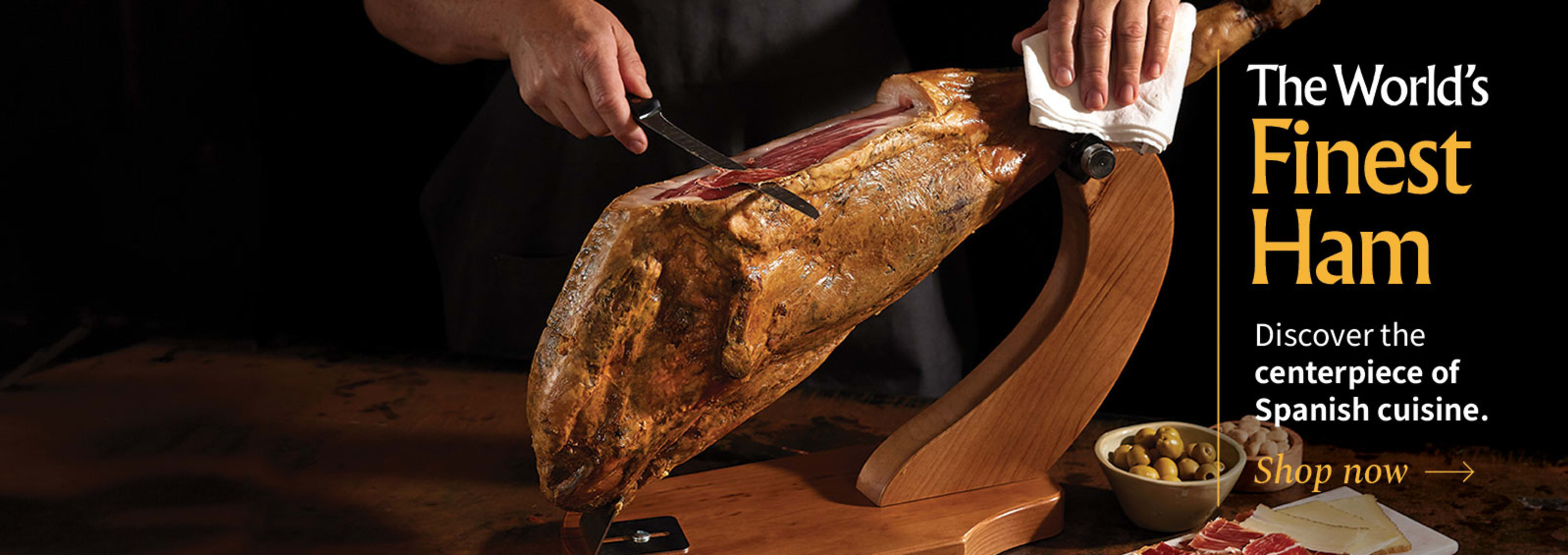 Sliced Jamon in a plate with some olives and a knife out of focus