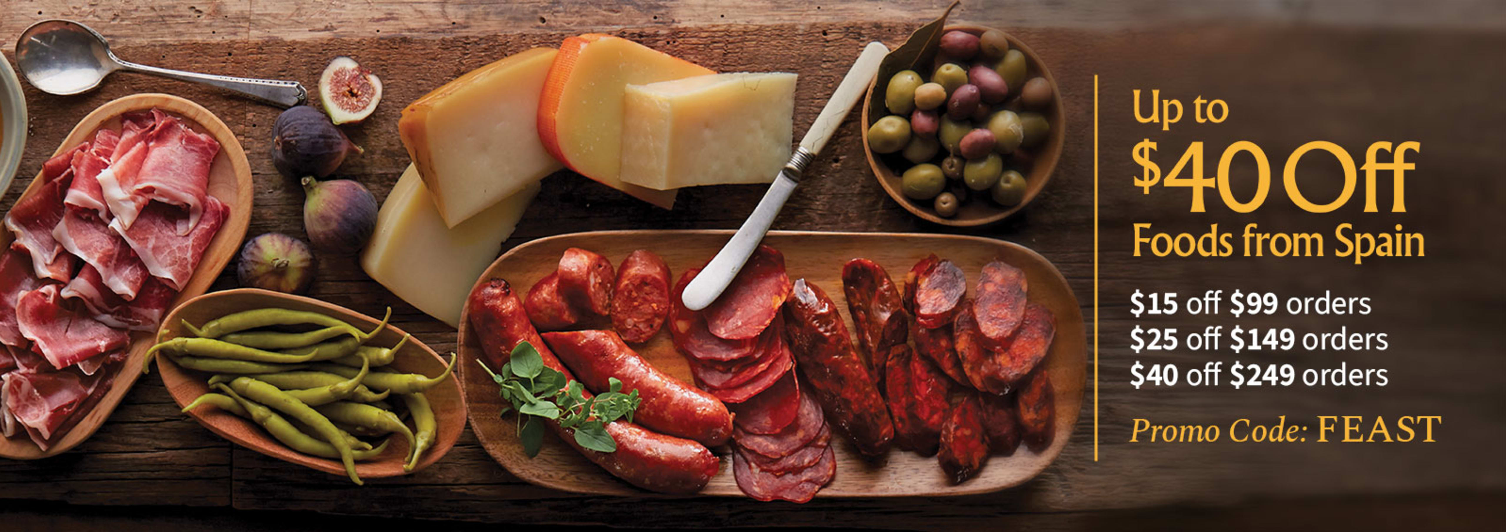 Sliced Jamon in a plate with some olives and a knife out of focus