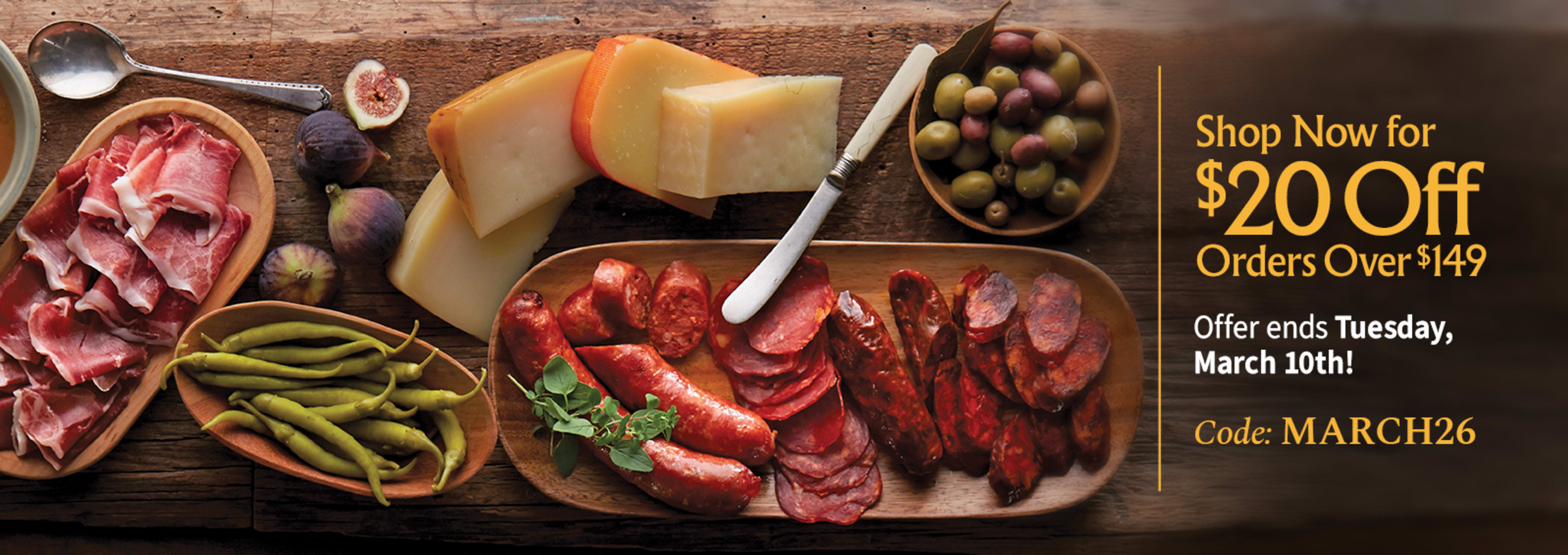 Sliced Jamon in a plate with some olives and a knife out of focus