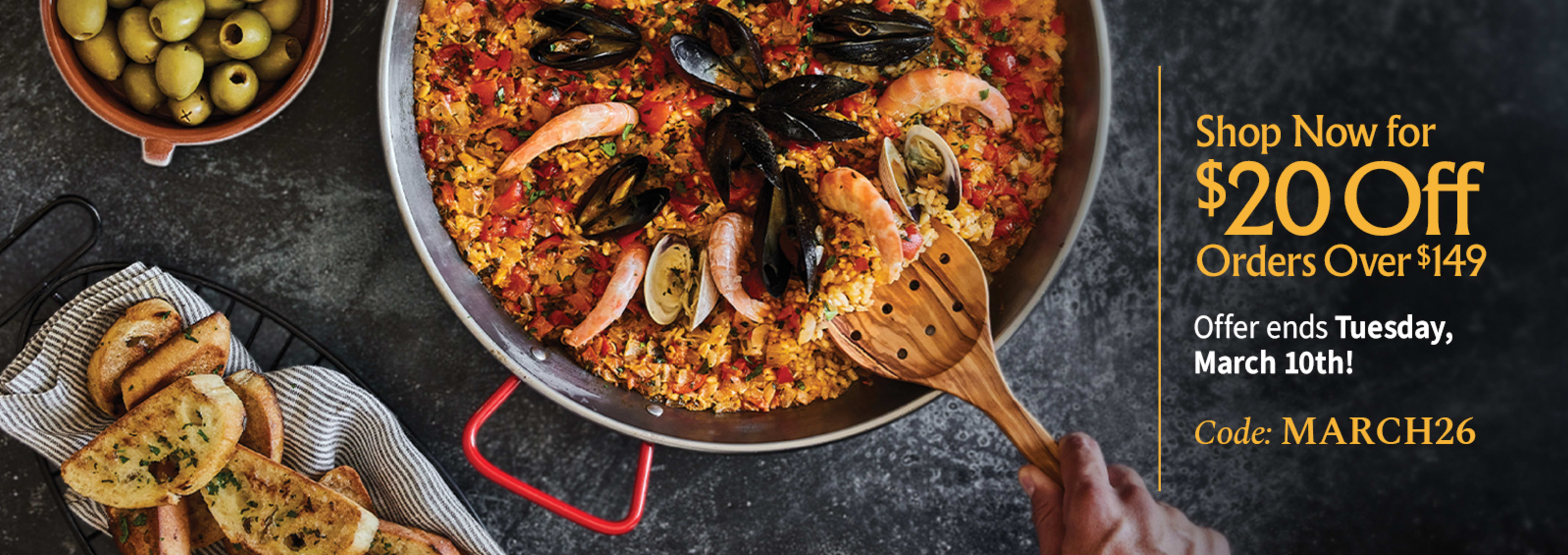 Sliced Jamon in a plate with some olives and a knife out of focus