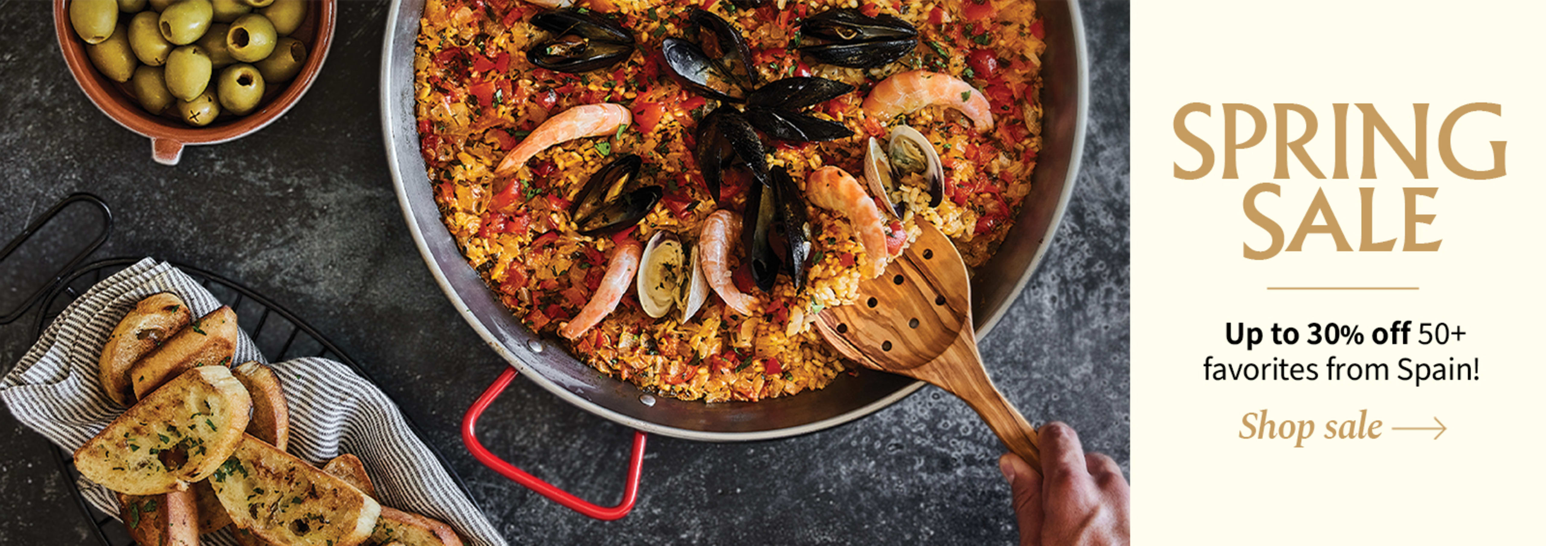 Sliced Jamon in a plate with some olives and a knife out of focus