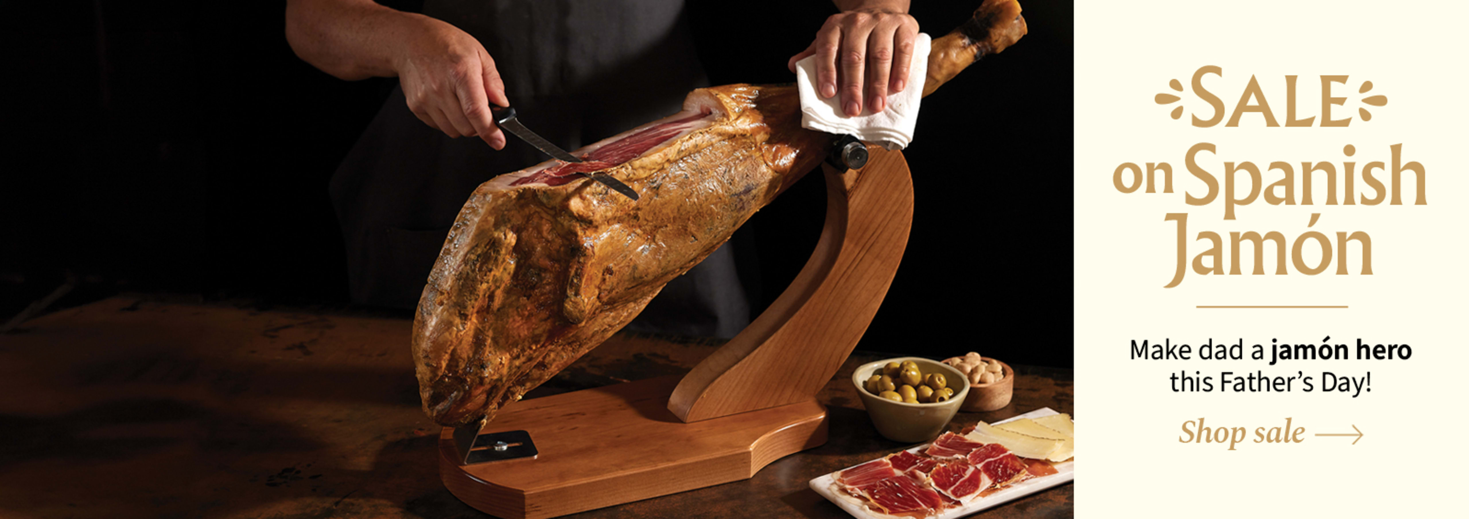 Sliced Jamon in a plate with some olives and a knife out of focus