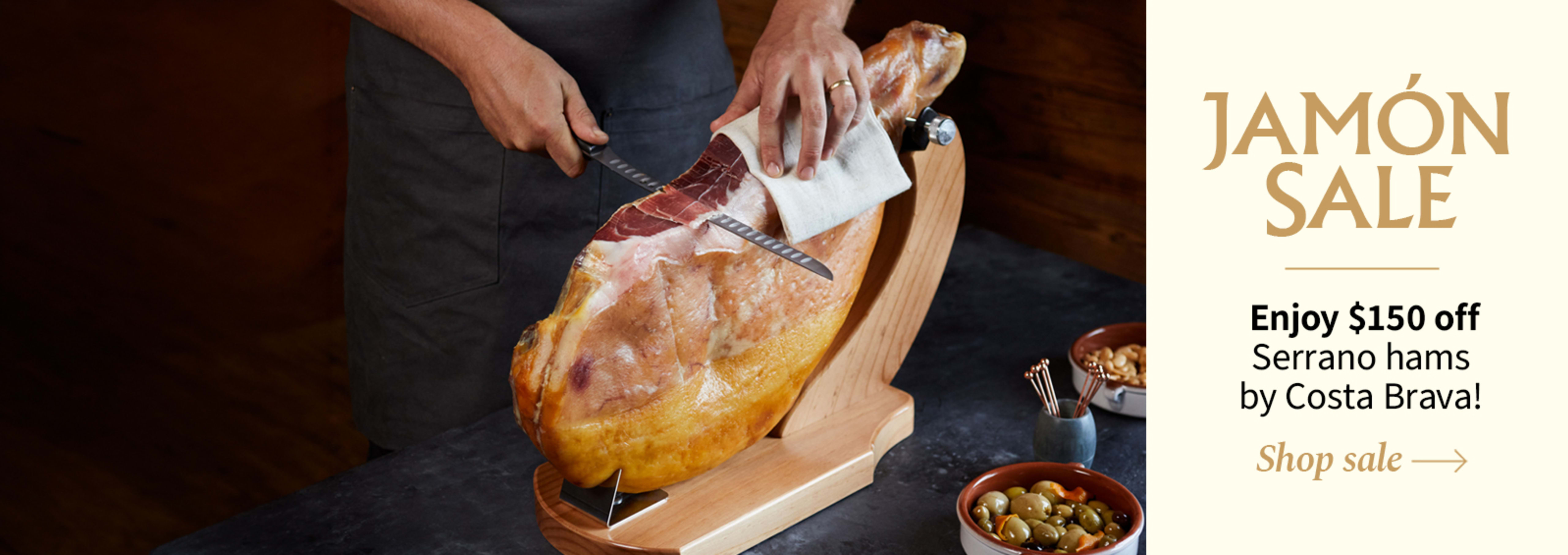 Sliced Jamon in a plate with some olives and a knife out of focus