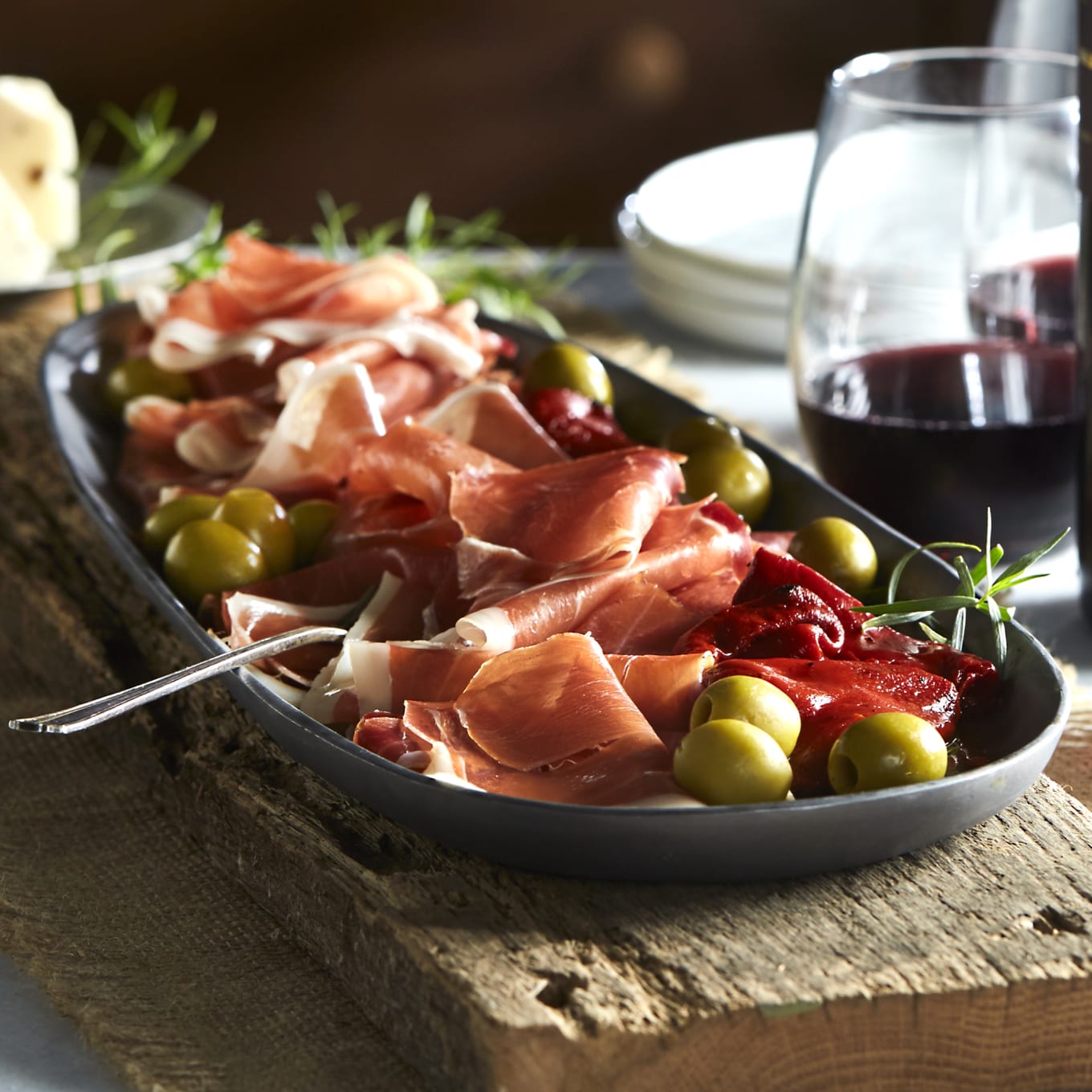 Spanish Jamon Serrano, tabla jamonera, jamonero knife with glass and bottle  of wine. Food photo concept Stock Photo - Alamy