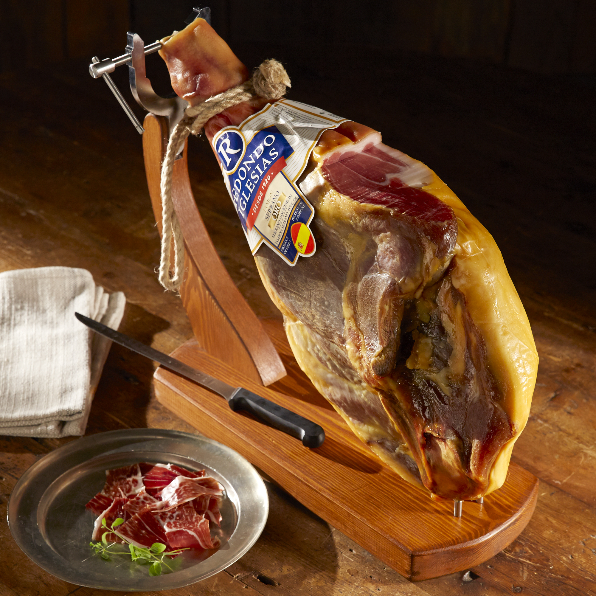 Spanish Jamon Serrano, tabla jamonera, jamonero knife with glass and bottle  of wine. Food photo concept Stock Photo