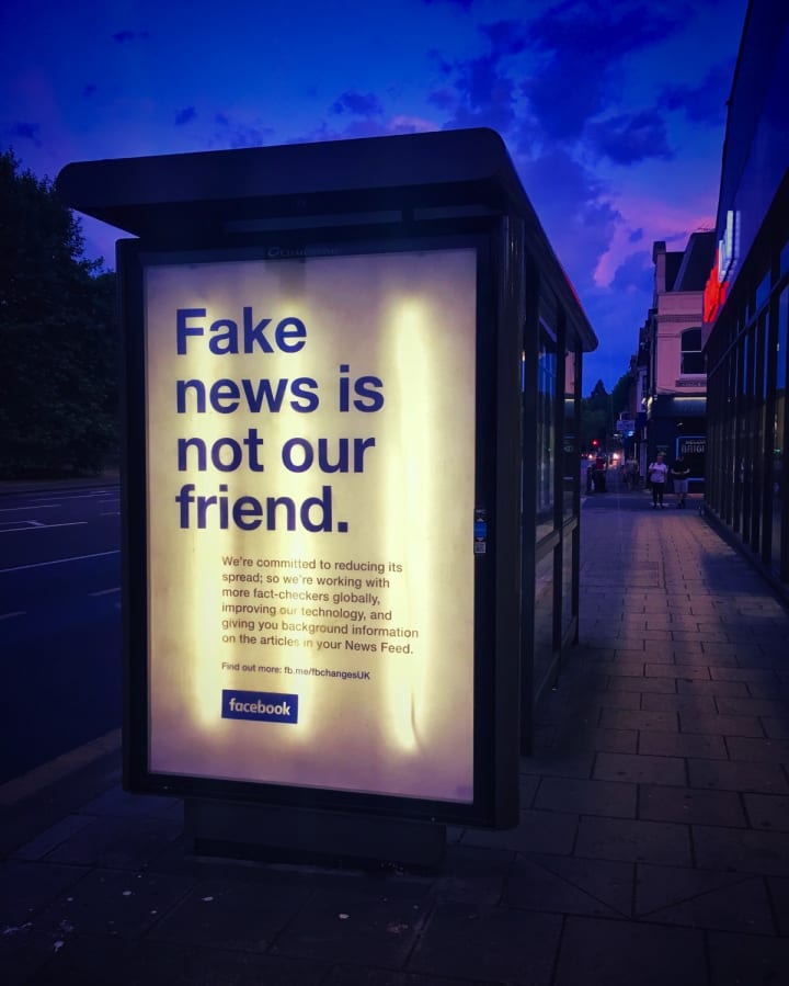 Advert on a bus stop that reads “Fake news is not our friend”