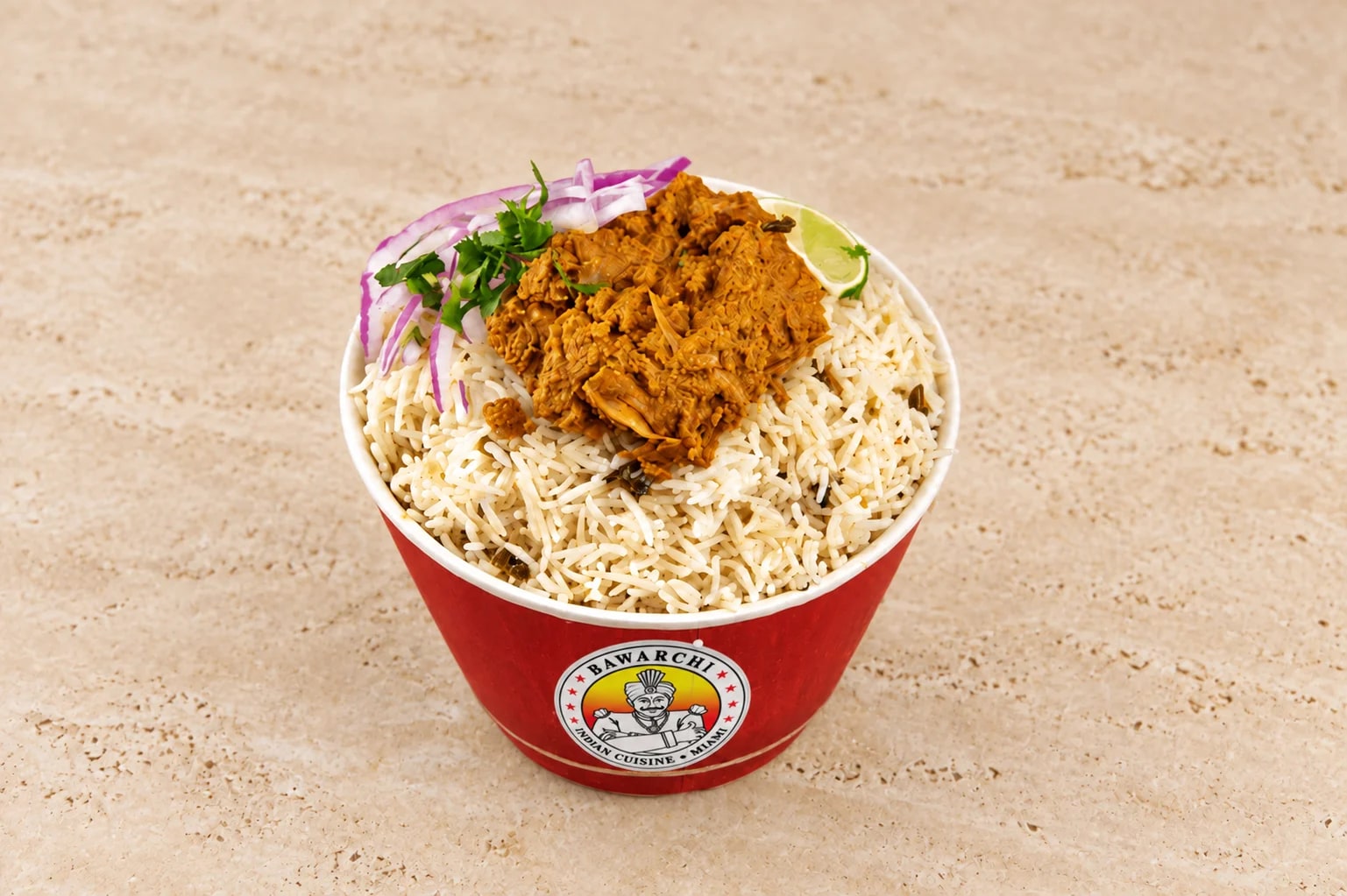 Bawarchi Boneless Biryani in a copper handi with curry and raita on the side
