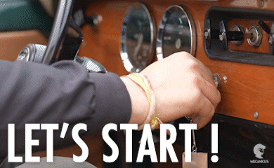 A hand starting a car by turning the keys