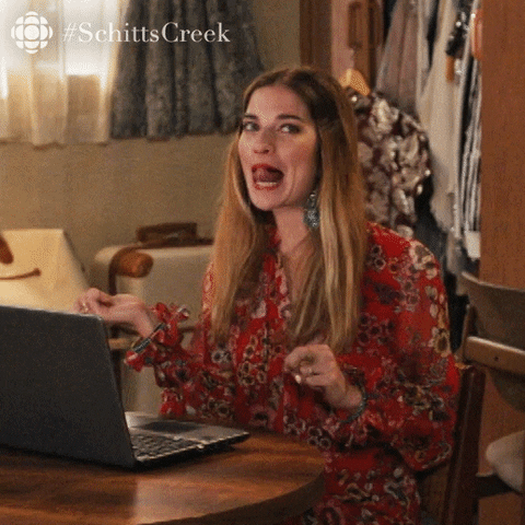 Lady flipping her hair in excitement (Image from giphy.com)