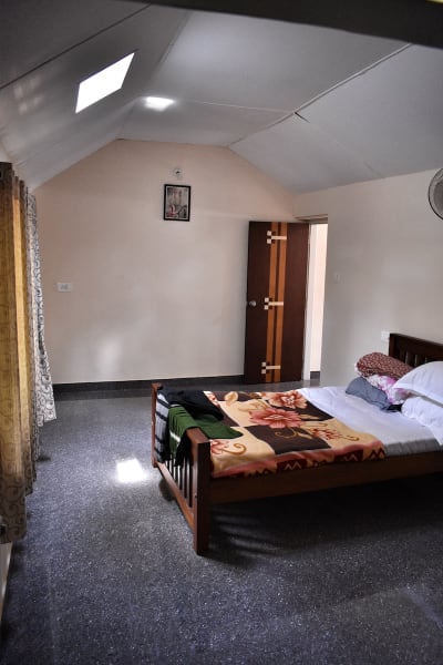 Cozy and well-lit bedroom interior at Rochas Valley, providing a peaceful retreat for guests