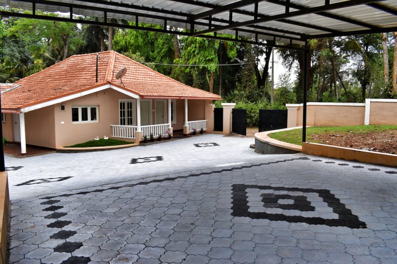 Wide-angle view of the Rochas Valley Homestay villa surrounded by serene coffee estates in Coorg