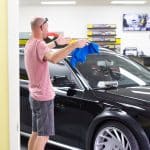 Tint World Employee Cleaning Windshield