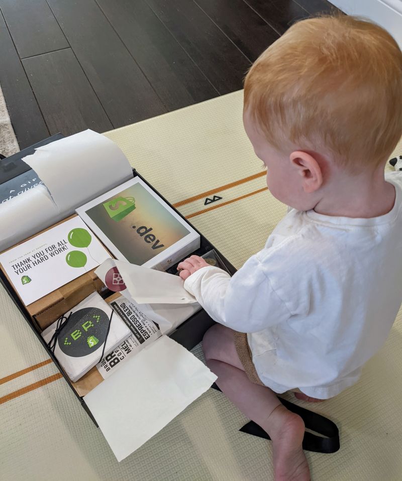 My son opening up the Shopify Swag