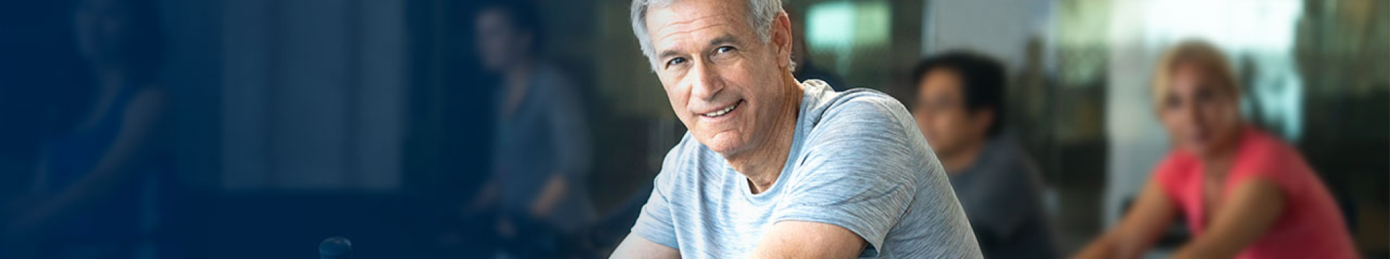 An elderly man looks into the camera after a workout