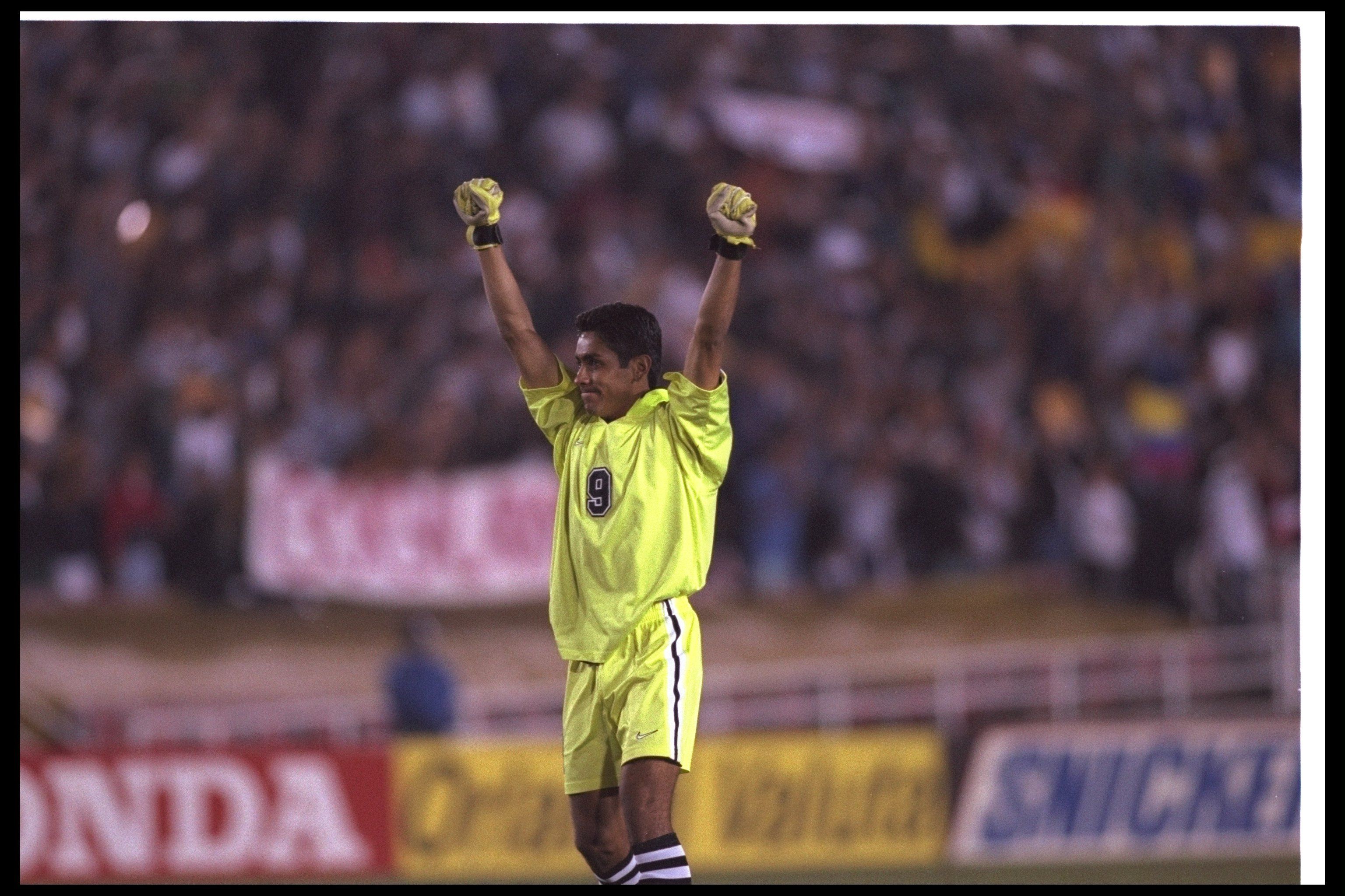 Mexican goalkeeper Jorge Campos wearing a yellow LA Galaxy kit with number nine on it, punching the air. (Goalkeeper.com)