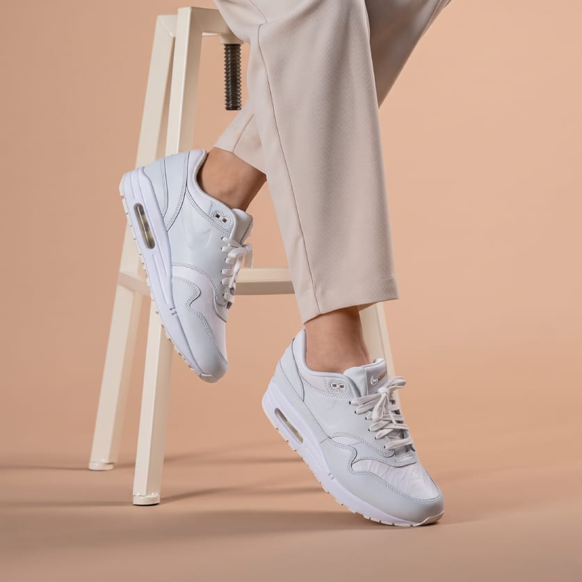 White Nike Air Max 1 sneakers on feet