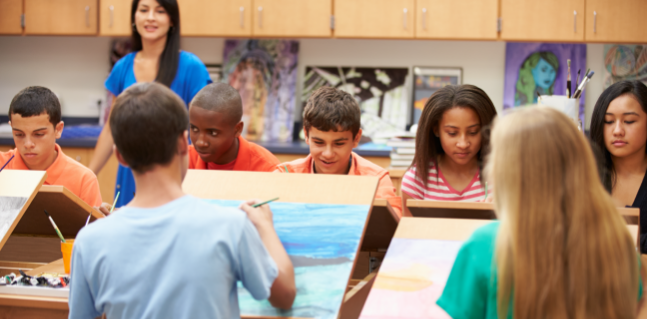 Teacher in class with students.