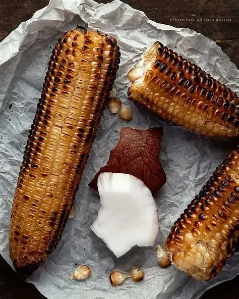 Ghanaian roasted corn served with fresh coconut