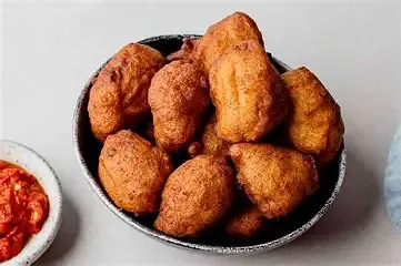 A woman preparing koose bean cakes in Ghana