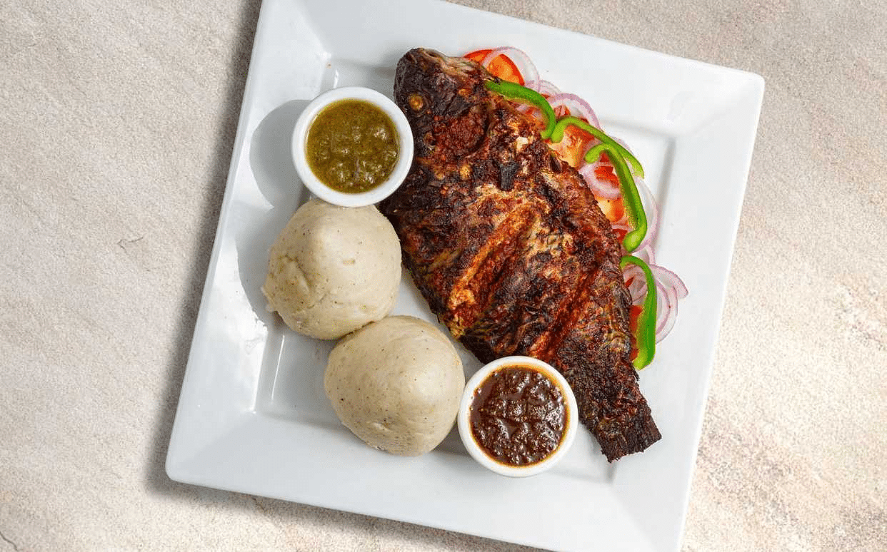 Ghanaian banku served with grilled tilapia and pepper sauce
