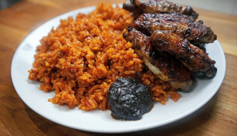 Jollof rice and grilled chicken served with Ghanaian shito