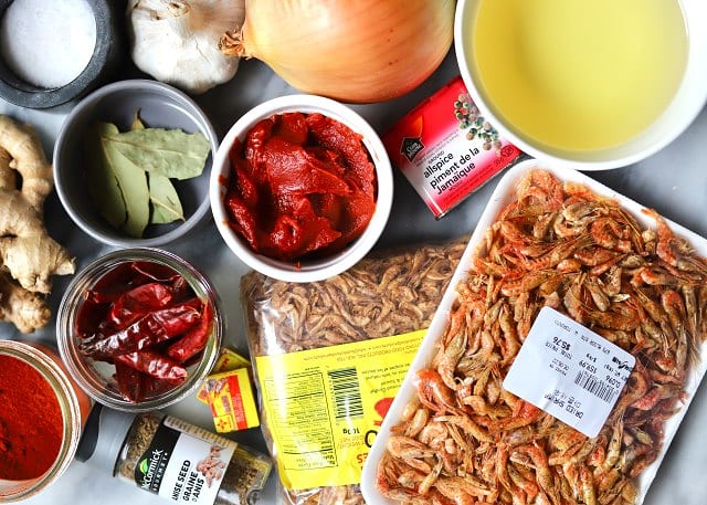 A seller displaying ingredients used for shito at Malam Atta Market in Accra