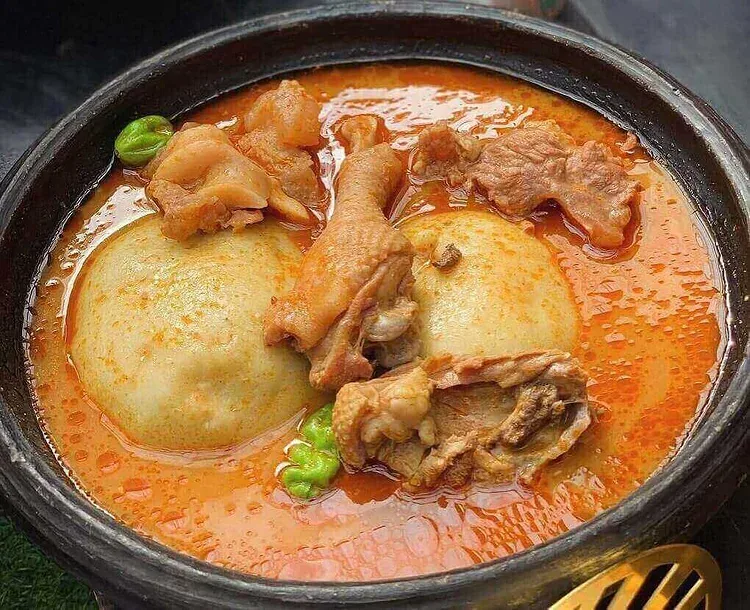 Ghanaian fufu served in light soup with meat