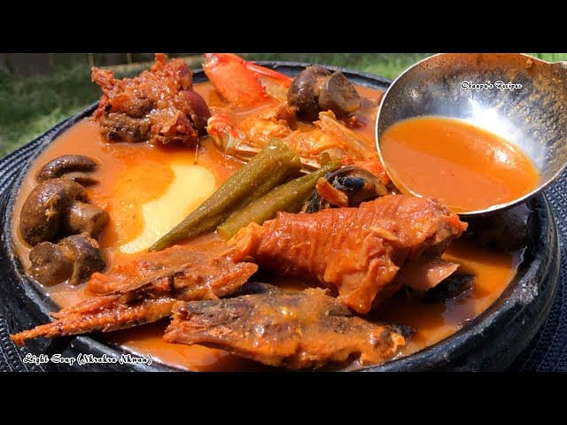 Ghanaian fufu served with groundnut soup, fish and meat