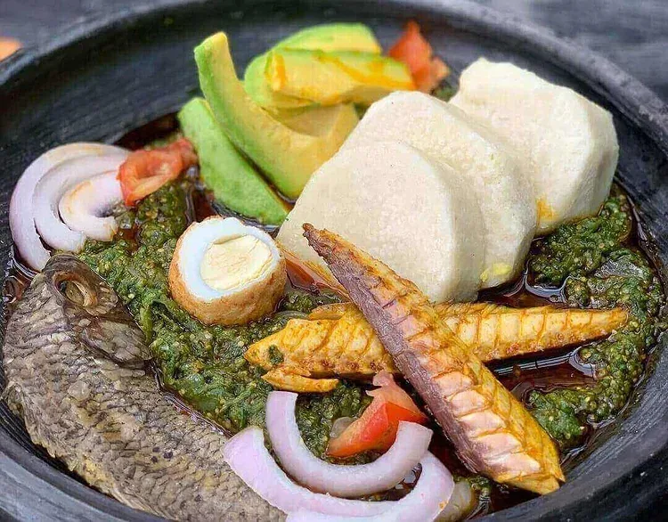 Boiled yam ampesi served with egg and palava sauce