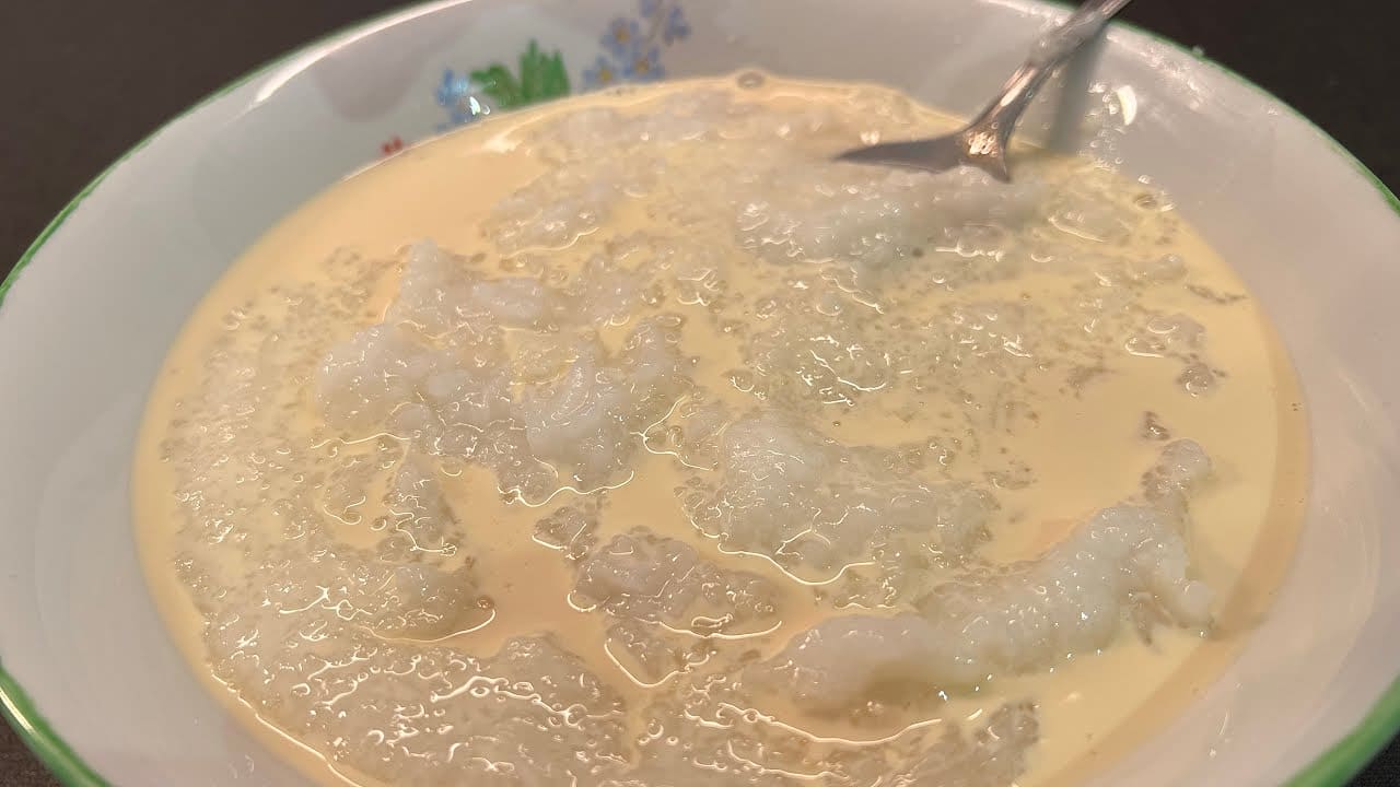 Rice porridge cooking in a pot, illustrating the soft texture of Ghanaian rice water