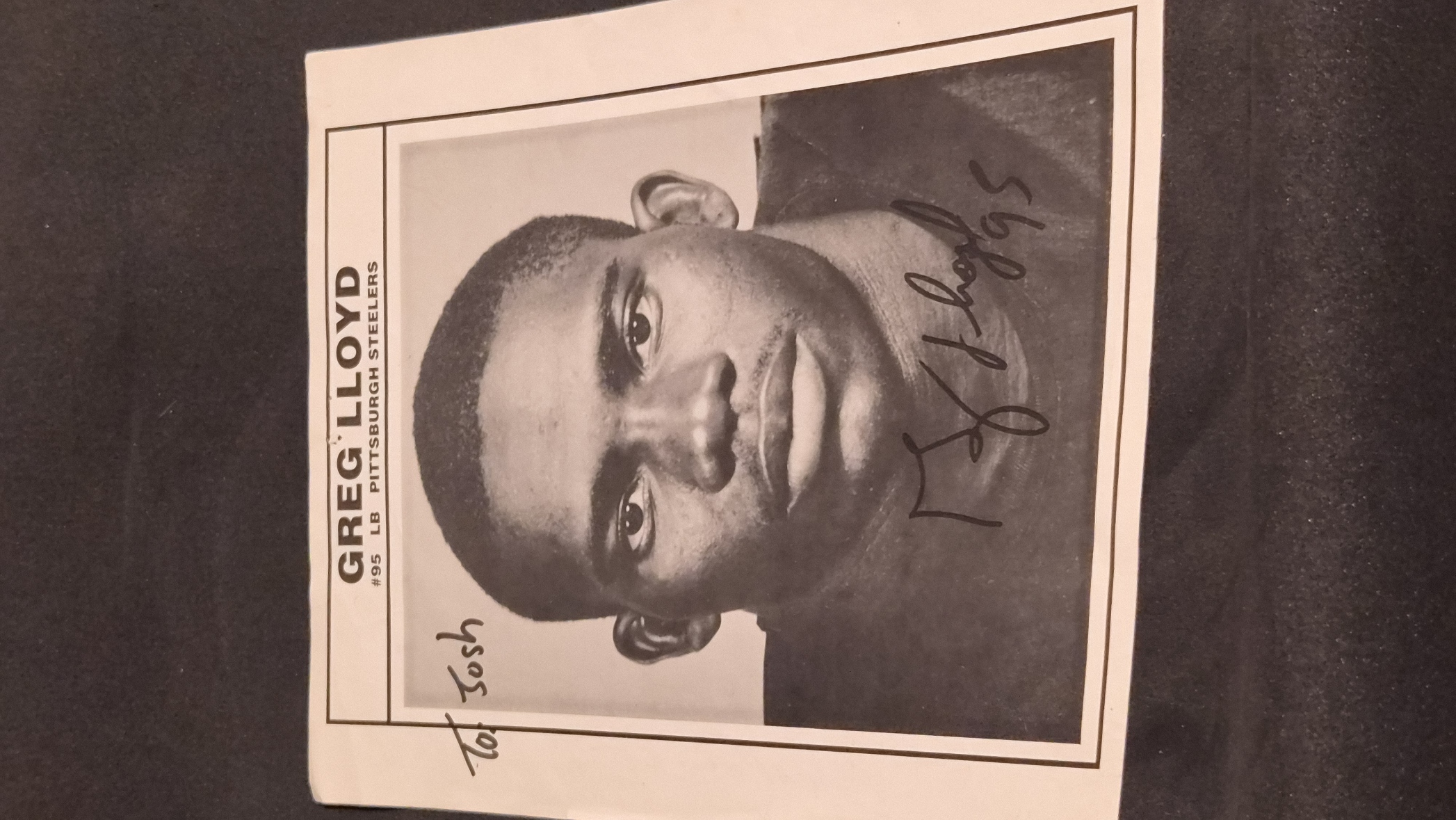 a black-and-white autographed photo of Greg Lloyd, the legendary three-time First-team All-Pro linebacker for the Pittsburgh Steelers.