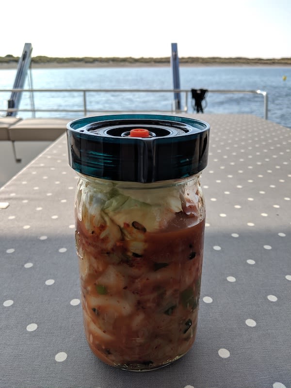 Kimchi in a jar with a fermenting lid.