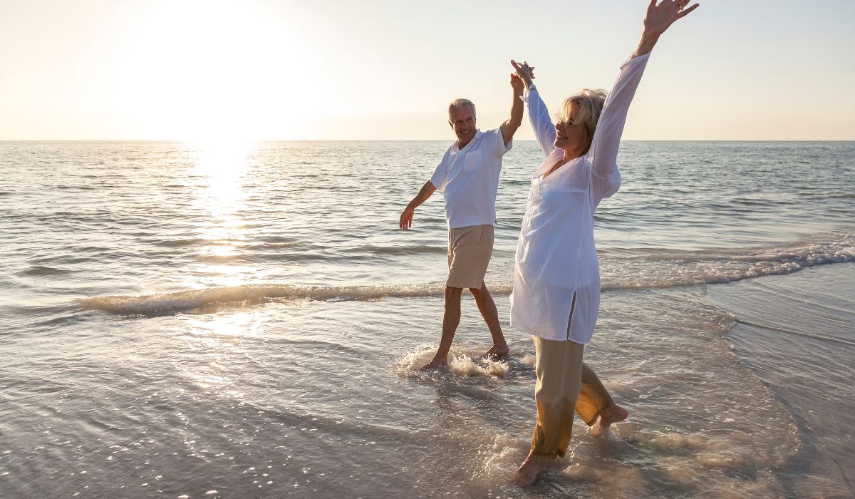 senior couple enjoying a walk on the beach