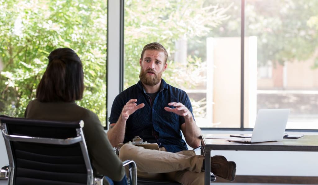 Therapist talking to her patient during a session